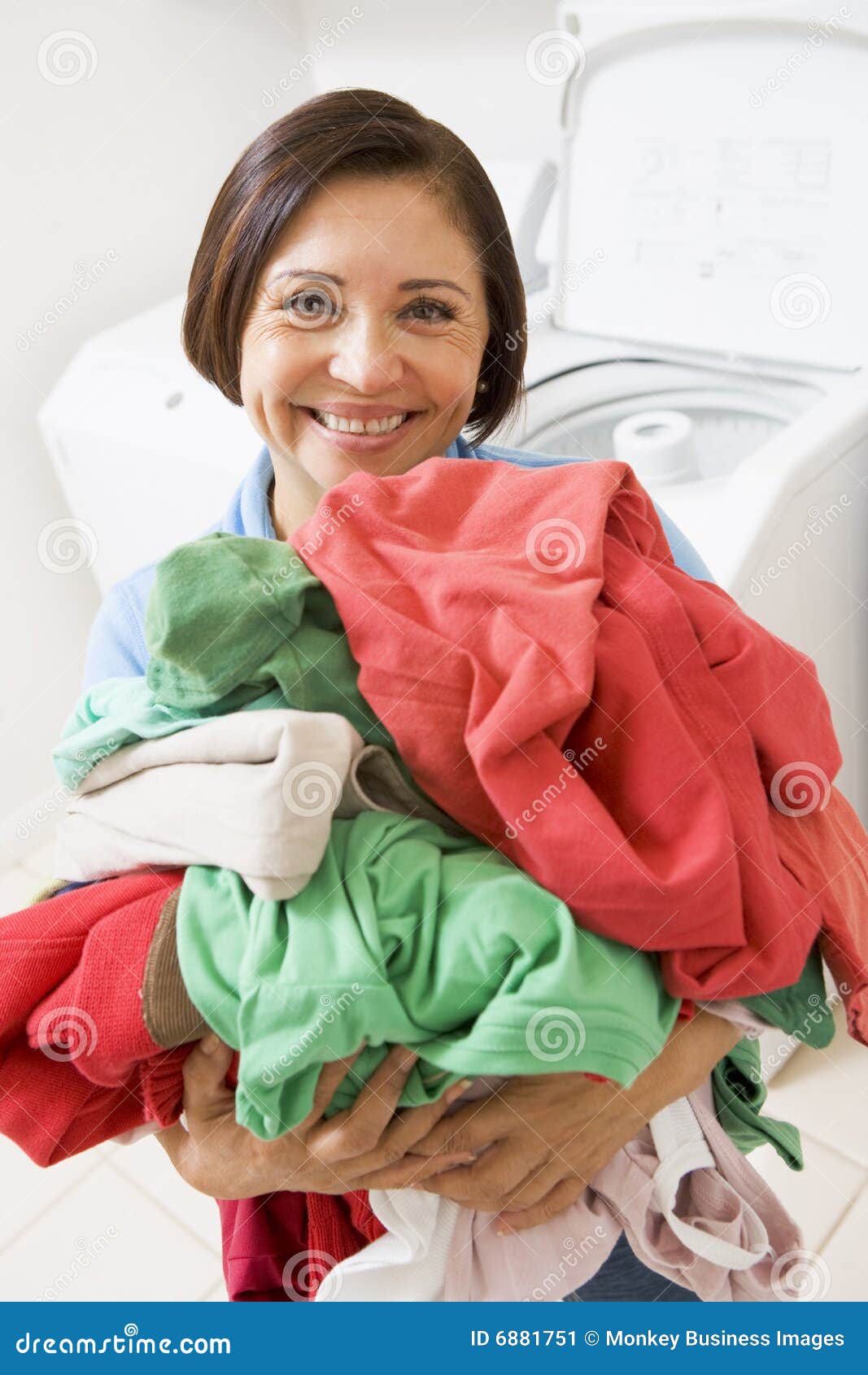 Woman Holding Pile Of Laundry Stock Image - Image: 6881751