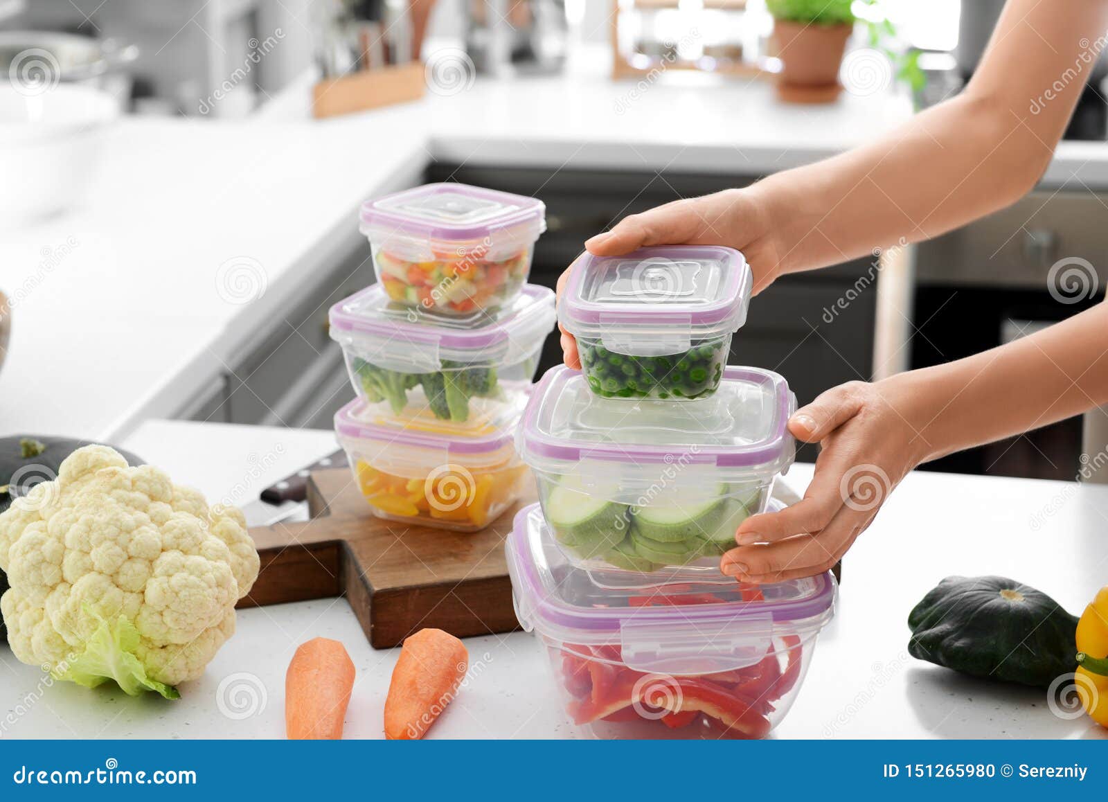 Woman Holding Stack of Plastic Containers with Fresh Vegetables for