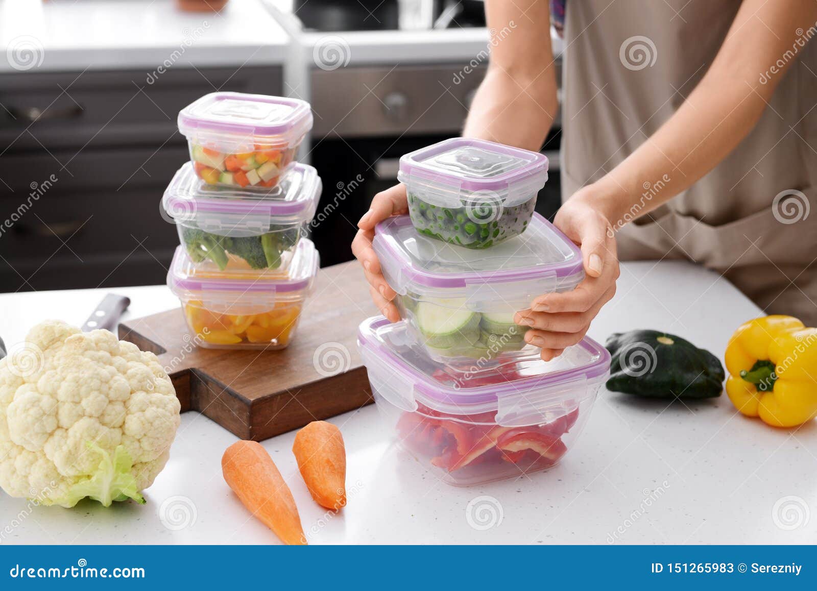 Woman Holding Stack of Plastic Containers with Fresh Vegetables for
