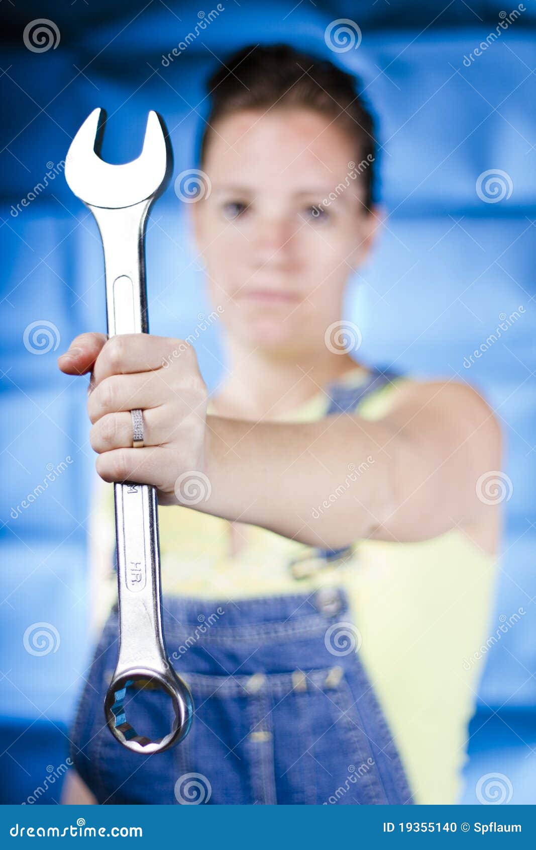 Woman holding wrench stock photo. Image of wrench, background 19355140