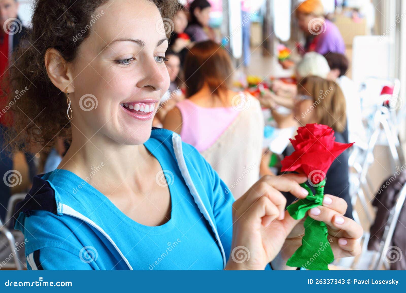 woman holds artificial red rose