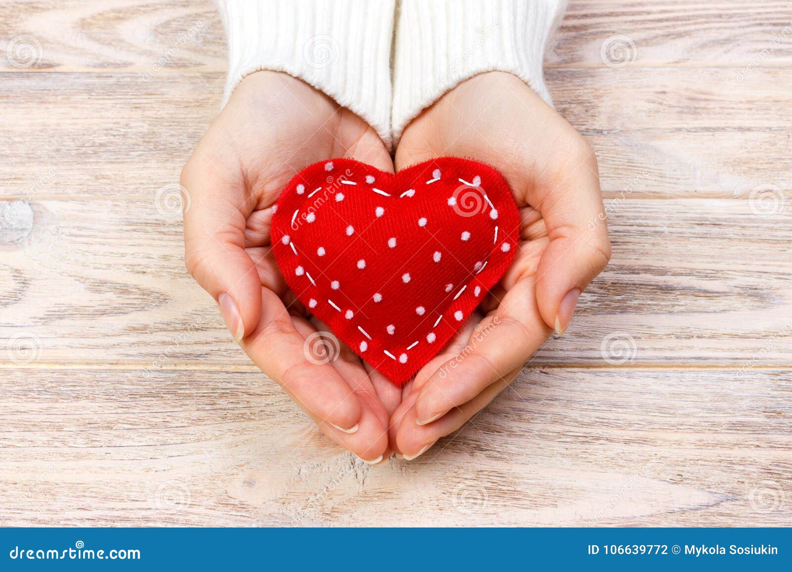 A Woman Holds a Red Heart in Her Hands. Love Concept Stock Photo