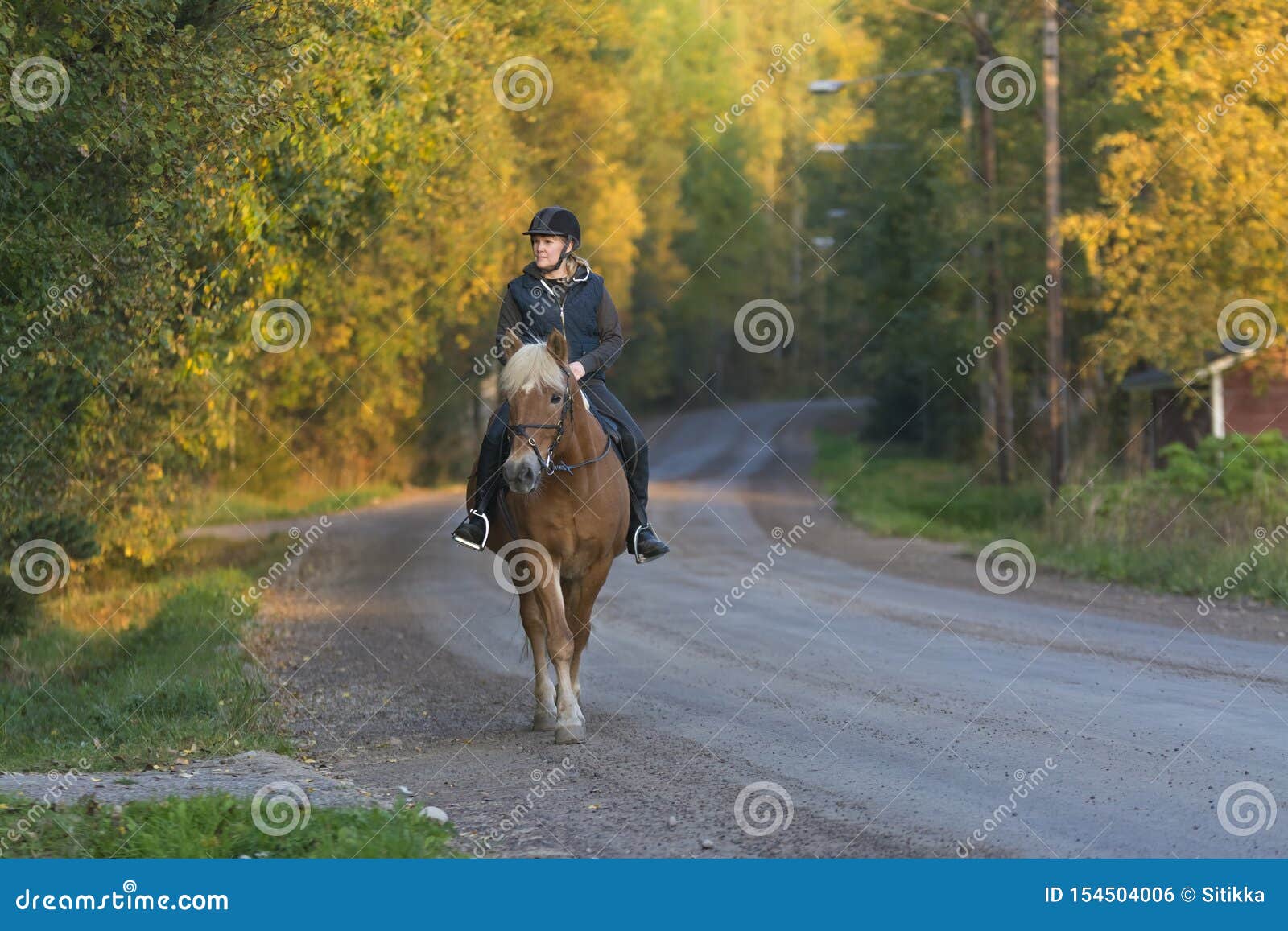 woman horseback riding in sunset