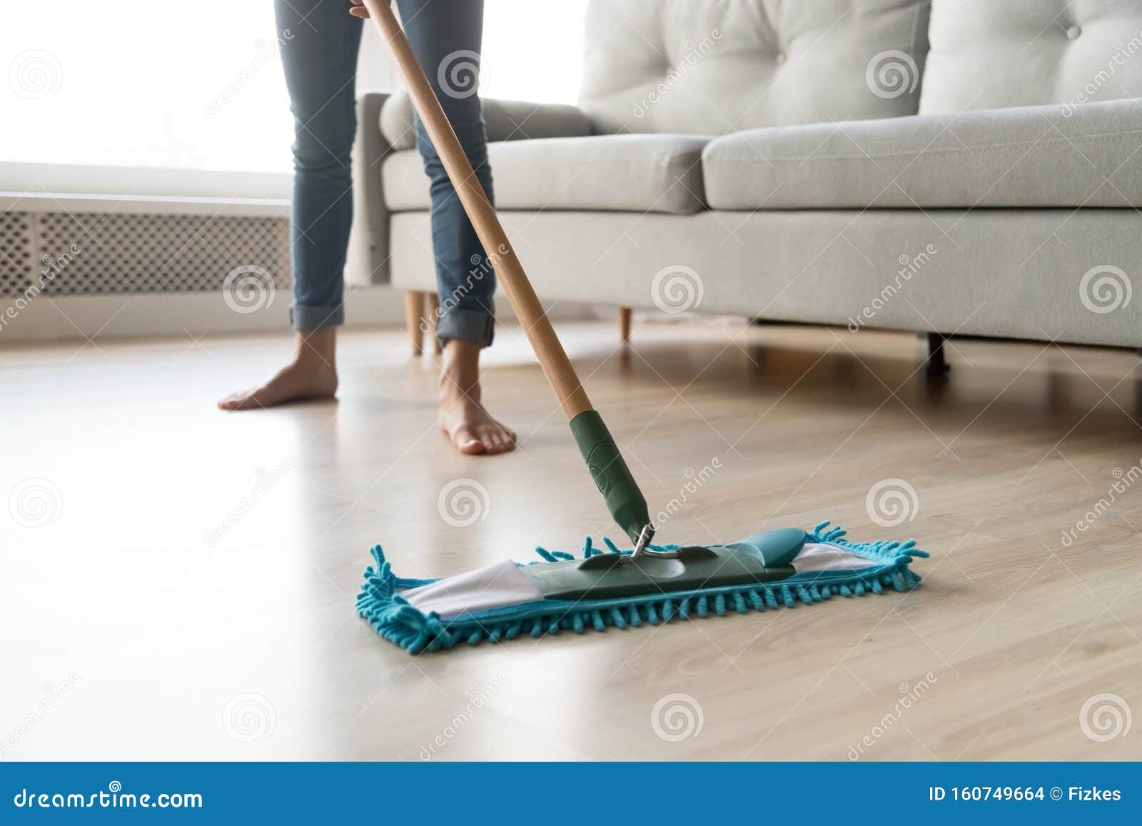 Woman Housewife Holding Mop Cleaning Floor At Home Close Up Stock