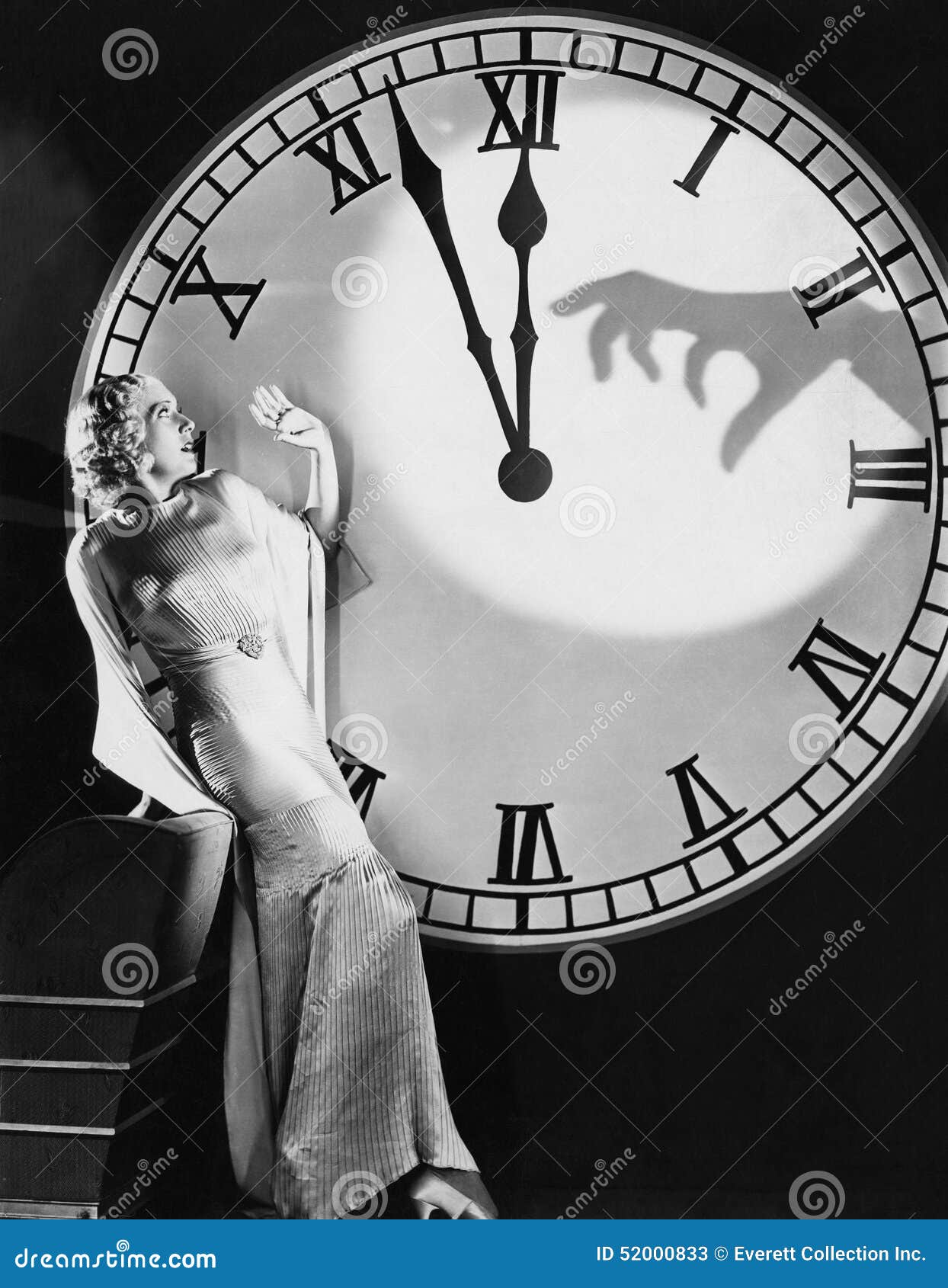 woman with huge clock recoiling from frightening hand