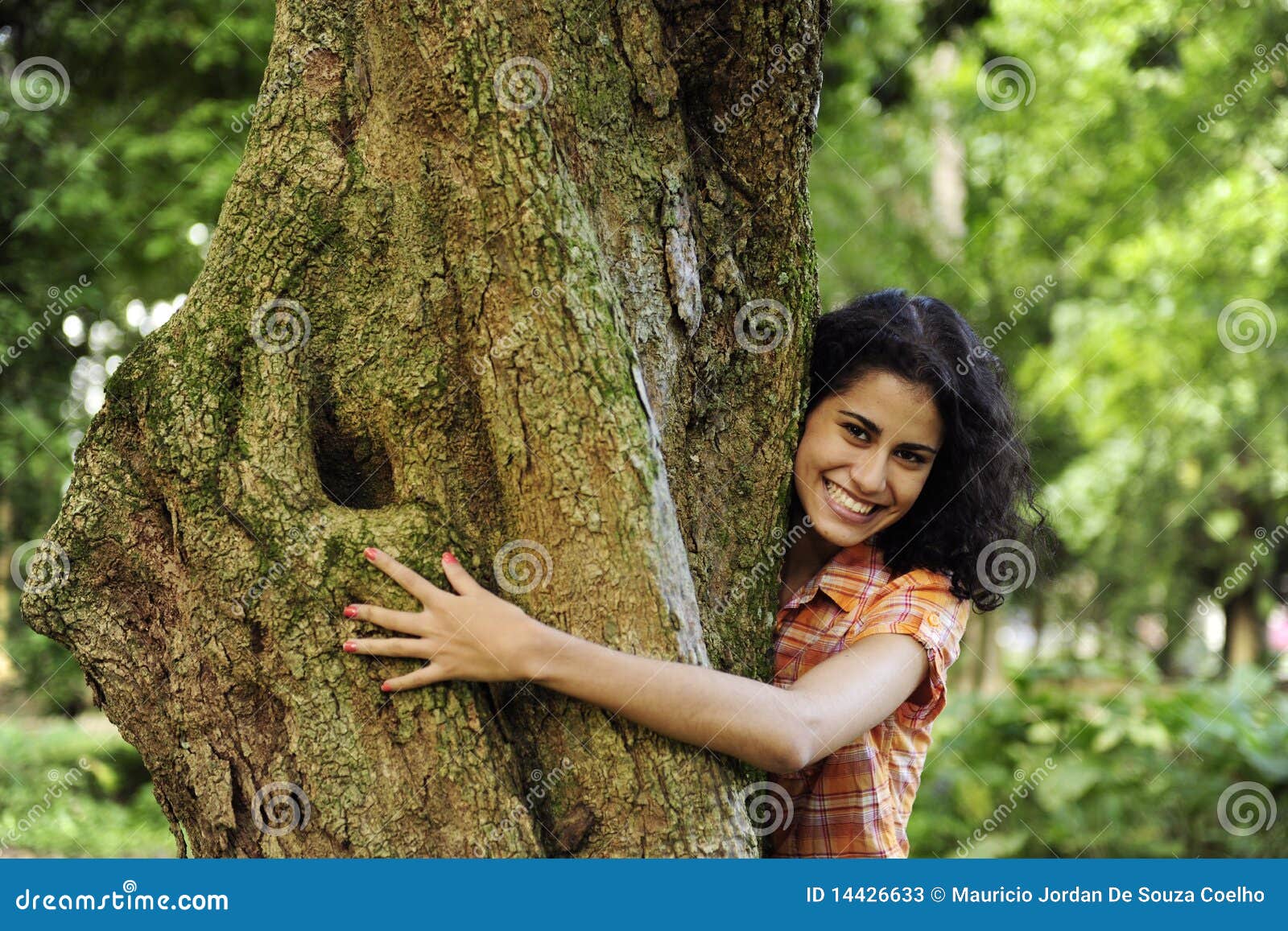 woman hugging a tree in the forest