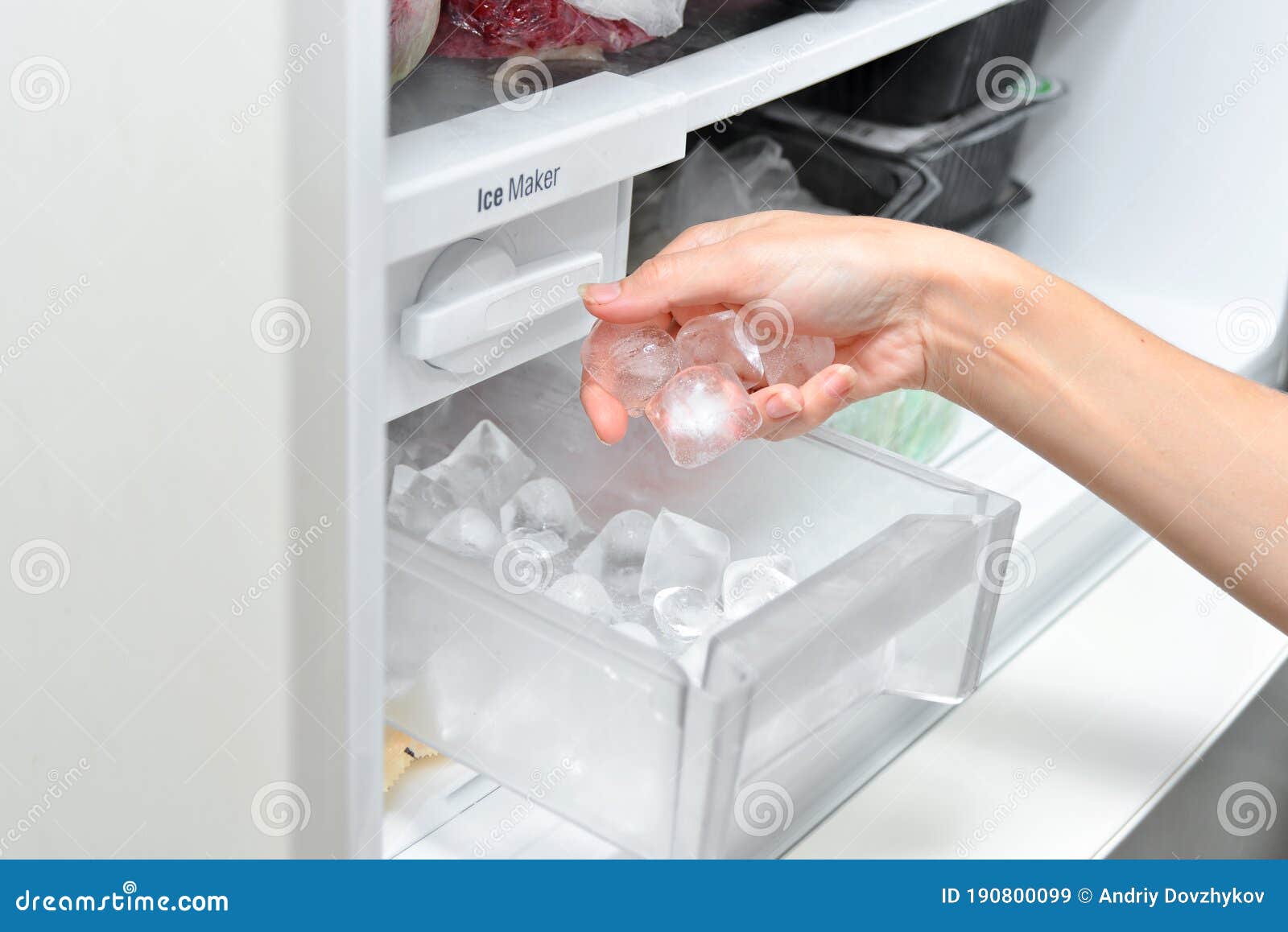 Ice cube maker in modern freezer with no-frost, houseold concept