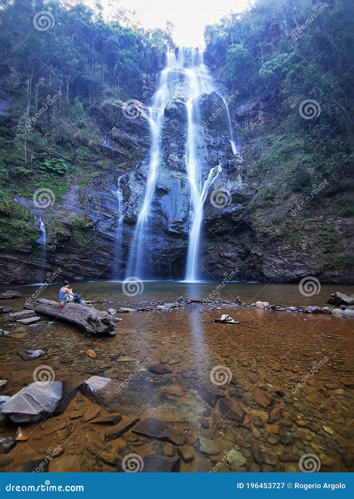 a woman in indio waterfall, rio acima, minas gerais, brazil.