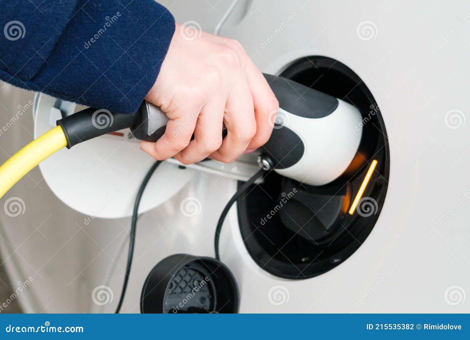 Woman Inserts the Power Supply Cable into an Electric Car for Charging Stock Photo Image of