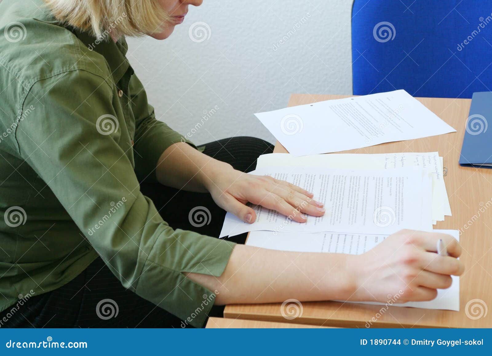 woman intently reading the documents