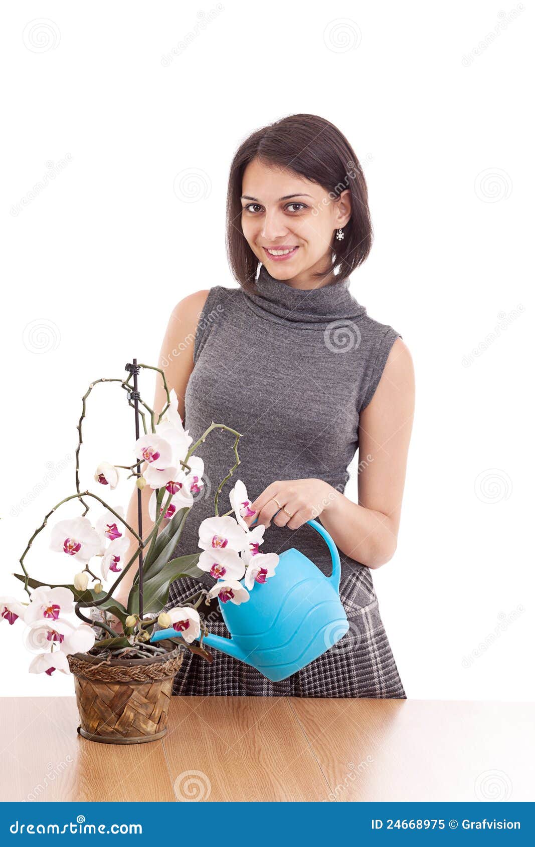 woman irrigate orchid