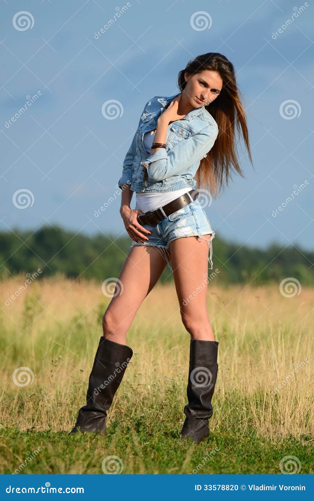 The Woman in Jeans Shorts in the Field Stock Photo - Image of ...