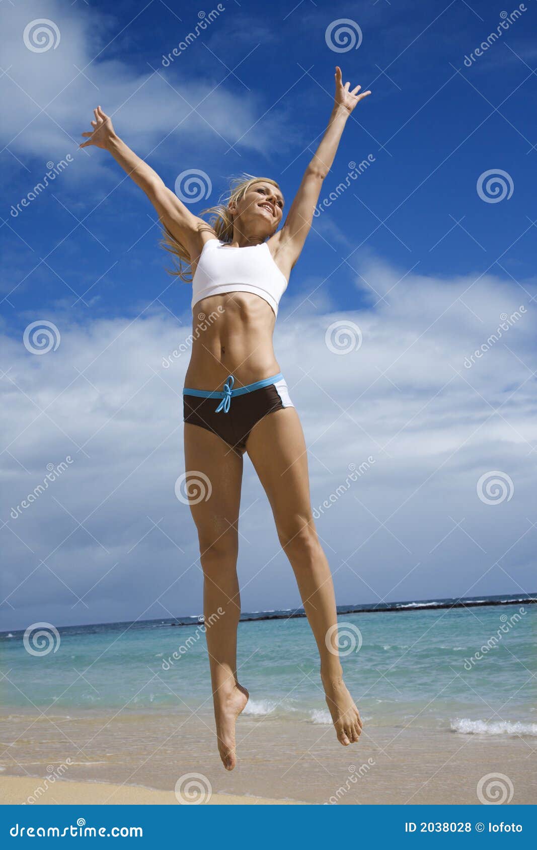 A Strong Girl With Big Muscular Arms On A Beach Stock Photo, Picture and  Royalty Free Image. Image 18043673.