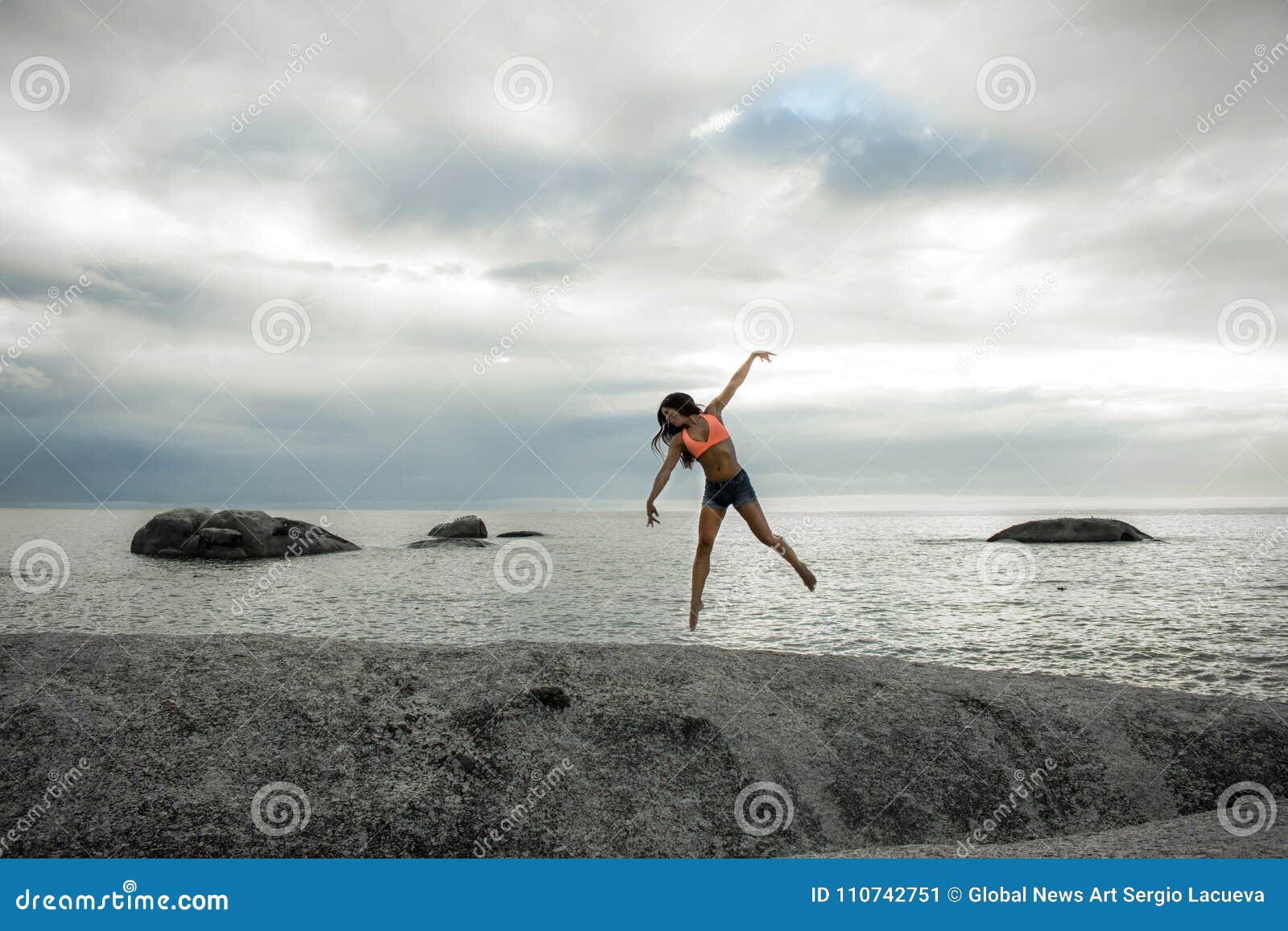 Woman Jumping On A Rock At Sunset On Bakovern Beach Cape Town Stock Image Image Of Shorts