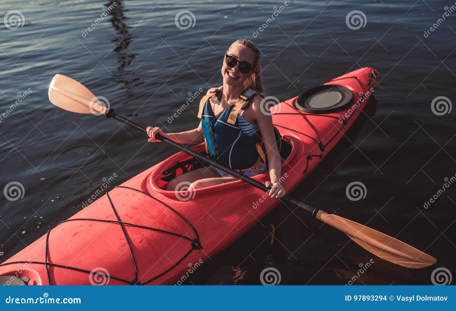 Woman kayaking on sunset stock photo. Image of adult 97893294