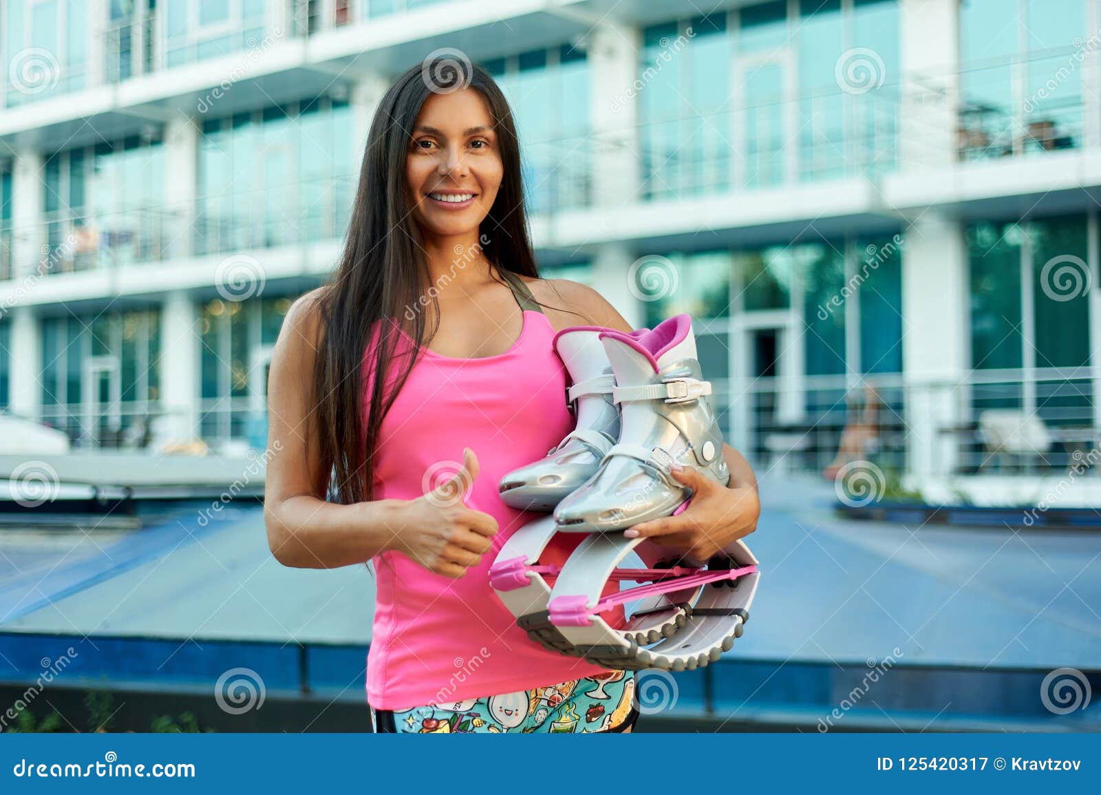 Two Women Put on Kangoo Jumping Boots and Smiles. Beautiful Girls