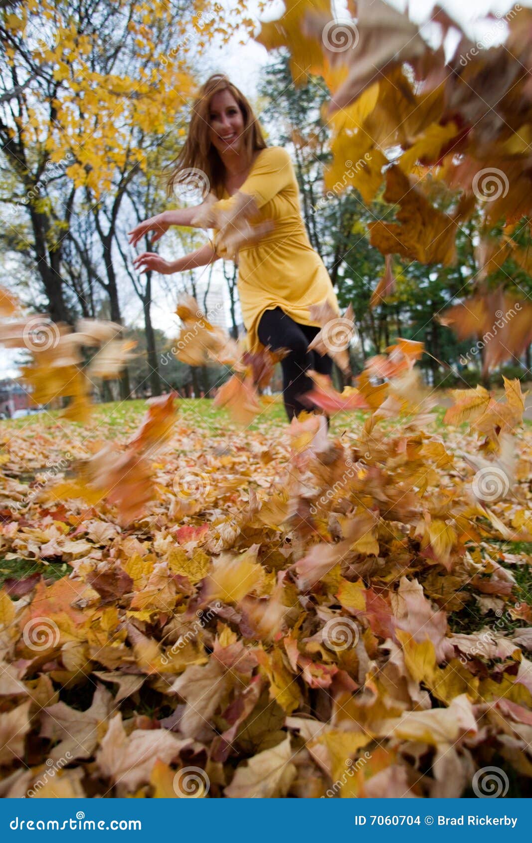 Woman kicks leaves stock photo. Image of play, twenties - 7060704