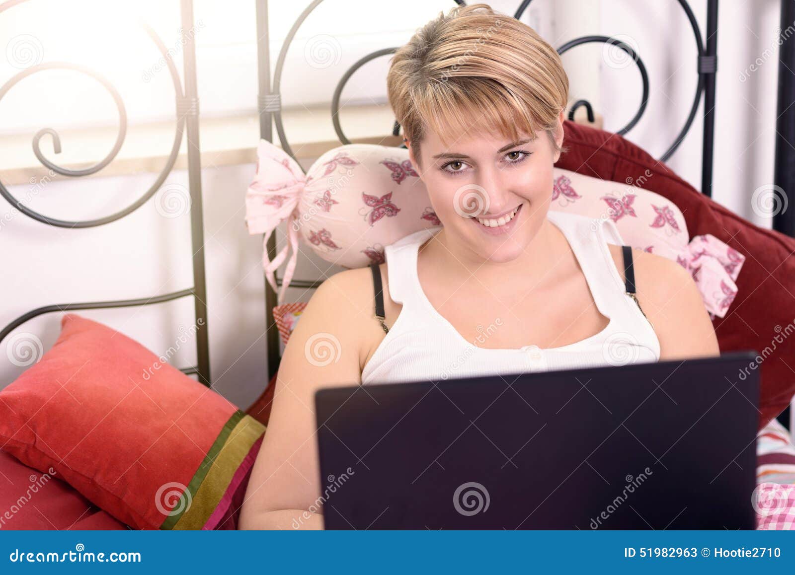 Woman with Laptop Leaning on Pillows on the Bed Stock Image Image of