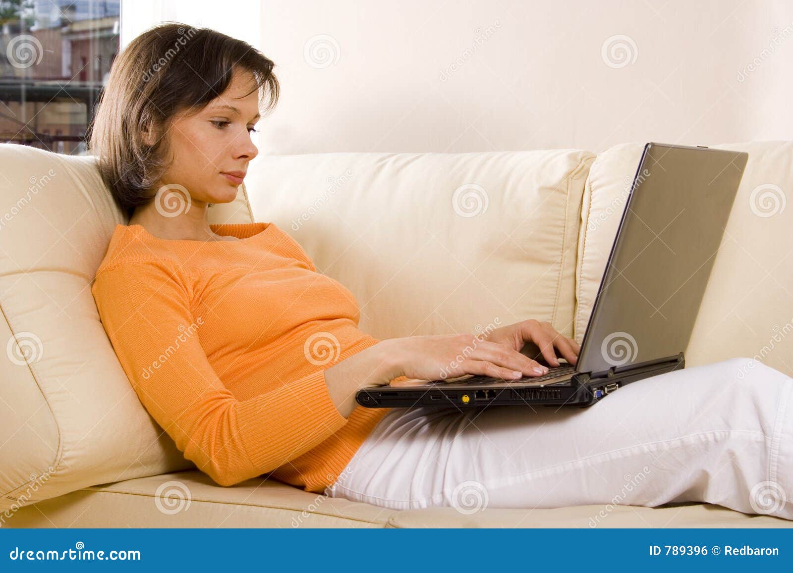 woman with laptop on the sofa