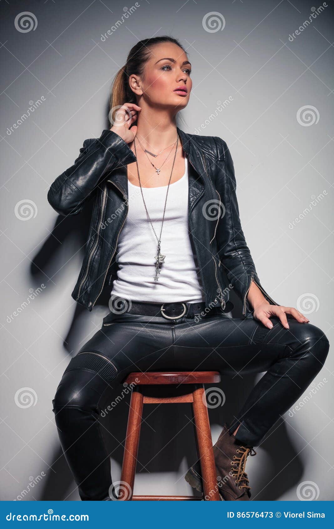 Woman in Leather Clothes with One Hand Behind Her Neck Stock Image ...