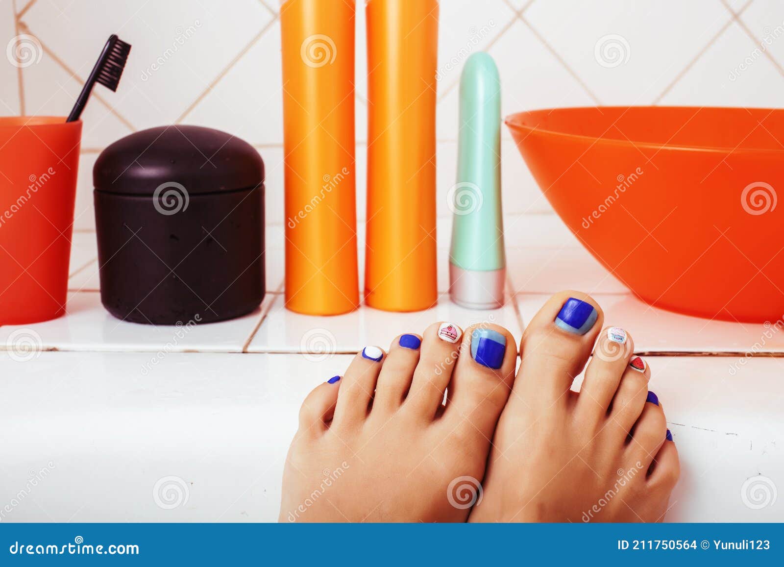 Woman Legs in Bathroom with Lot of Stylish Stuff for Care, Pedicure ...