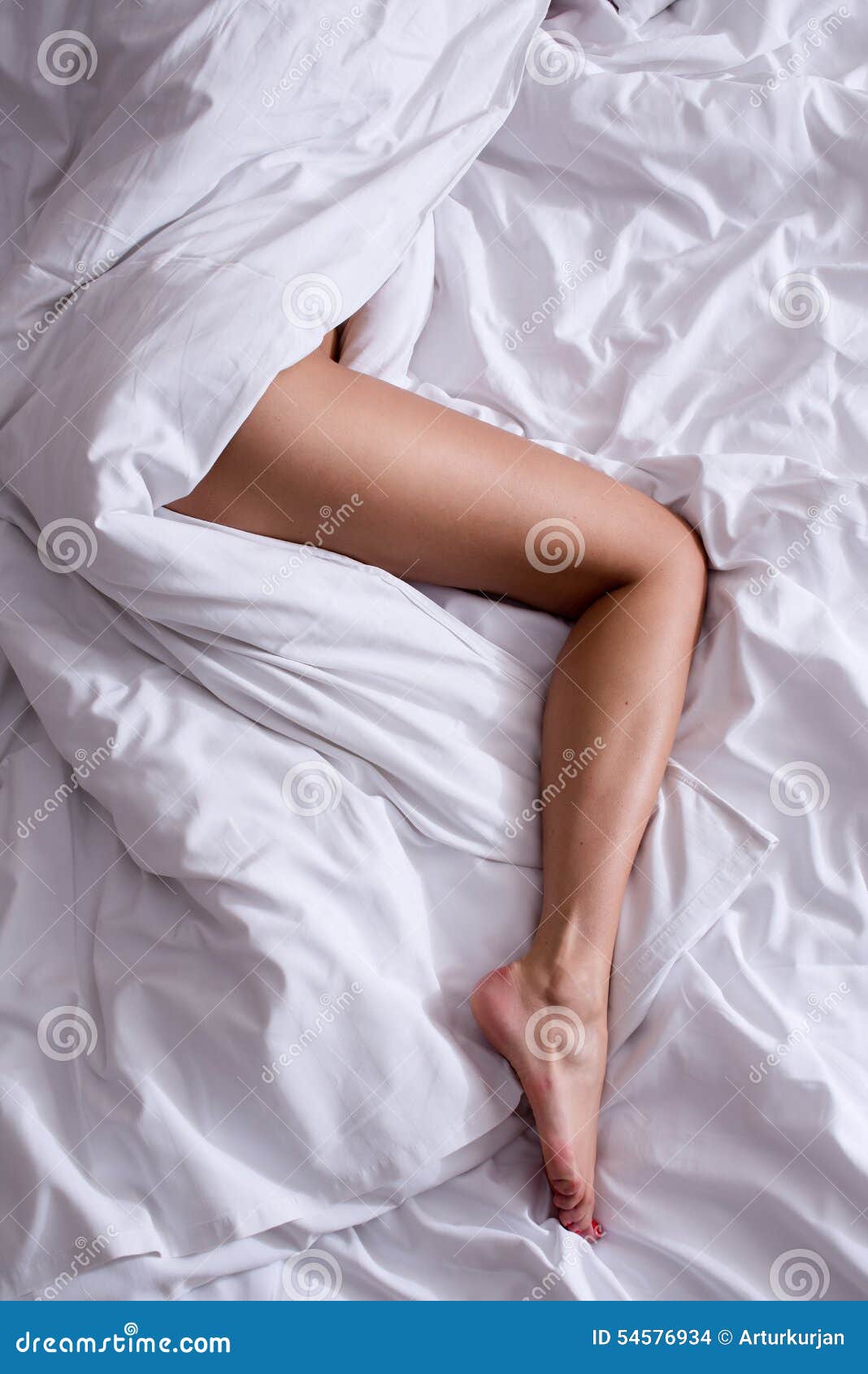 Woman legs on the bed stock photo. Image of pure, foot 54576934