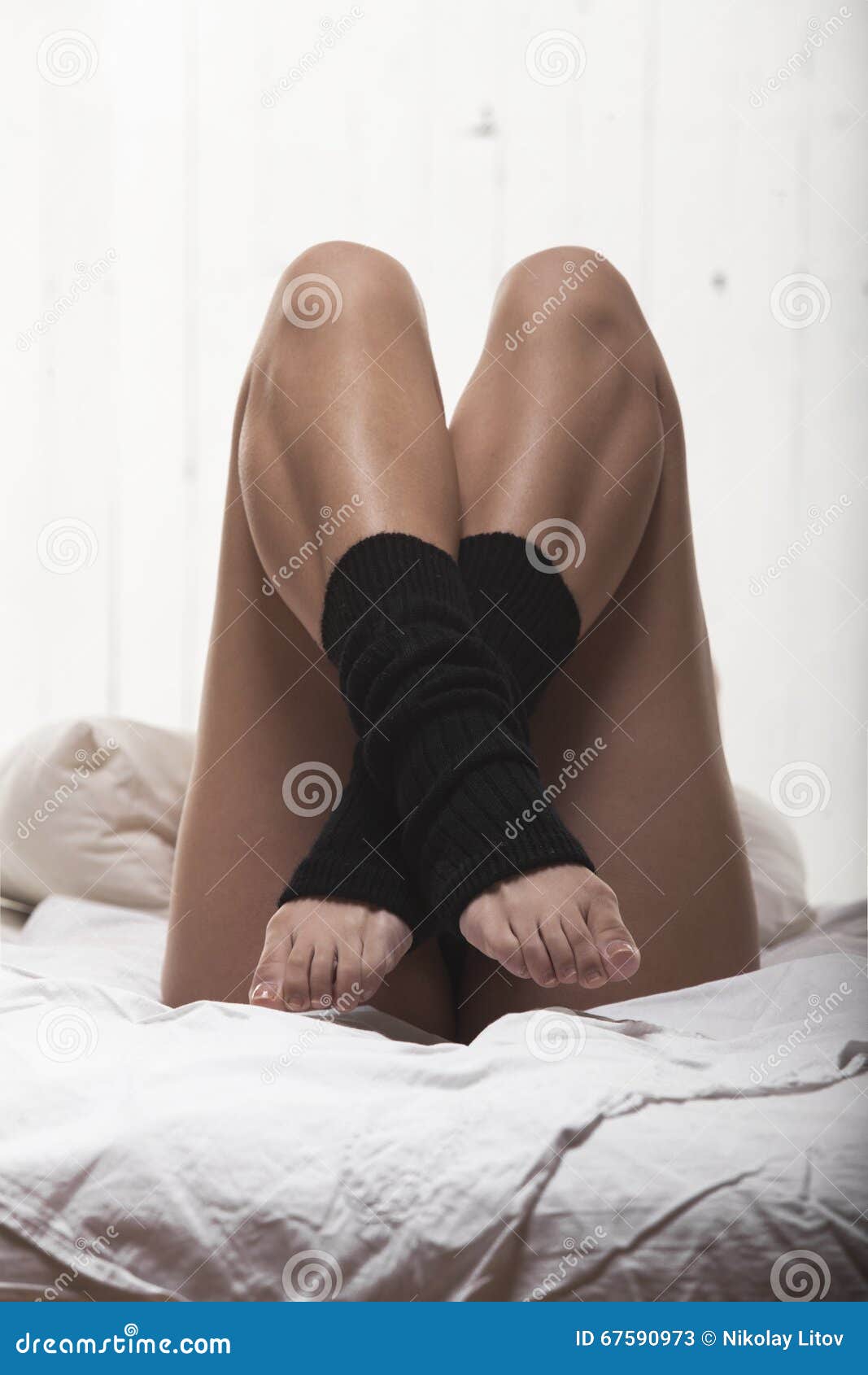 Woman legs on the bed stock image. Image of bedding, bedroom 67590973