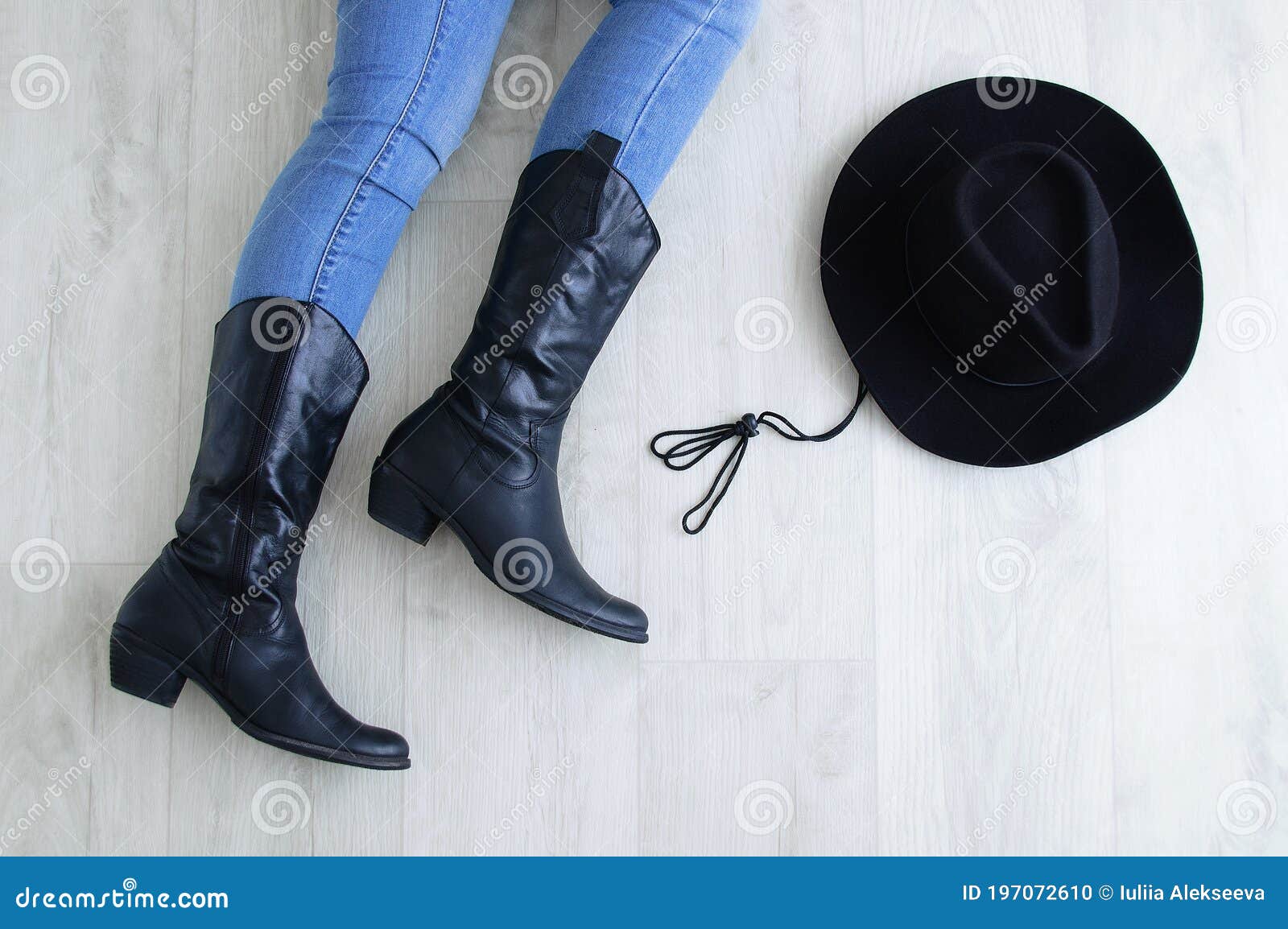 Woman Legs in Black Cowboy Boots with Cowboy Hat. Lying on a Gray ...