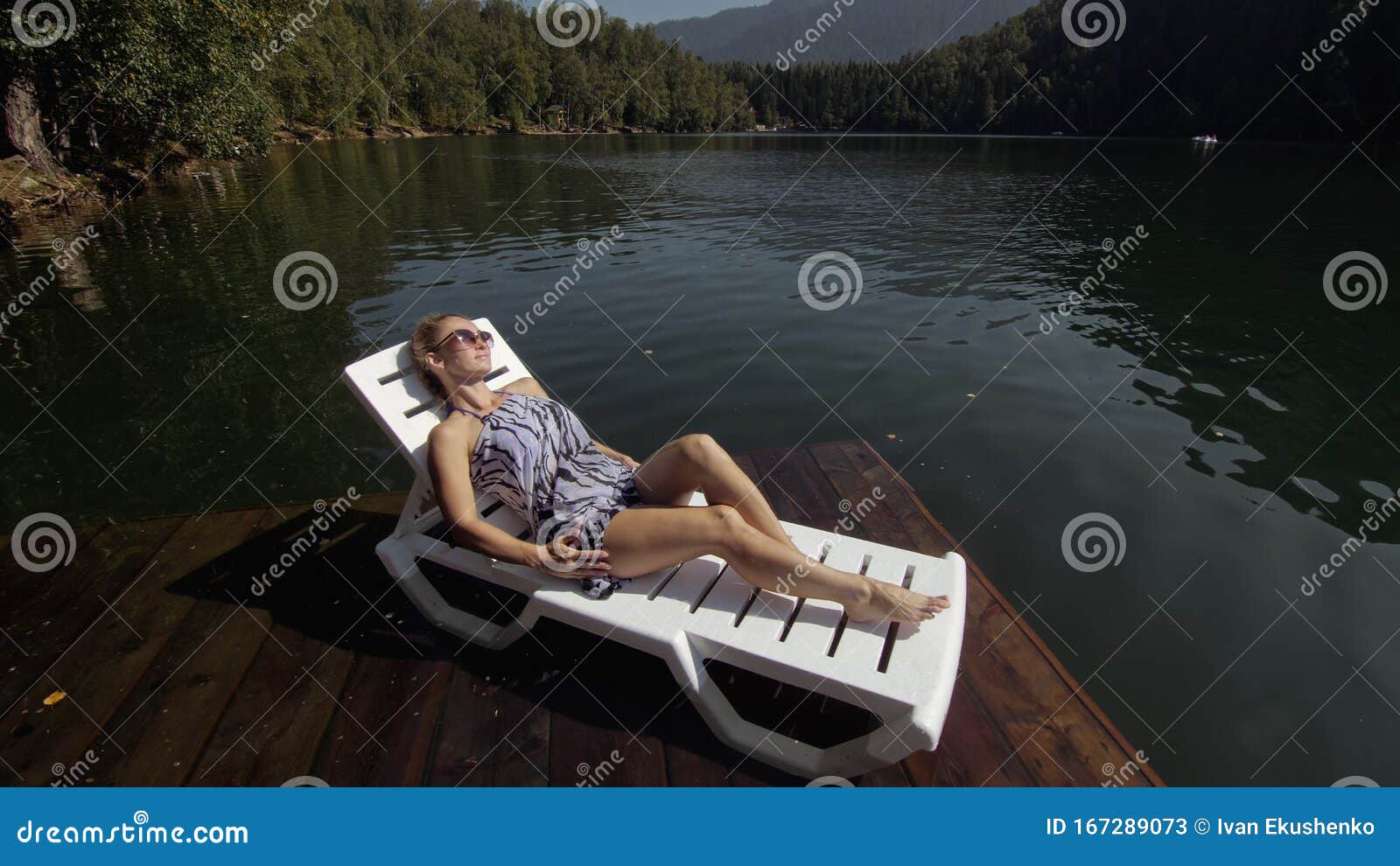 Woman Lie on a Sunbed in Sunglasses and a Boho Silk Shawl. Girl Rest on ...