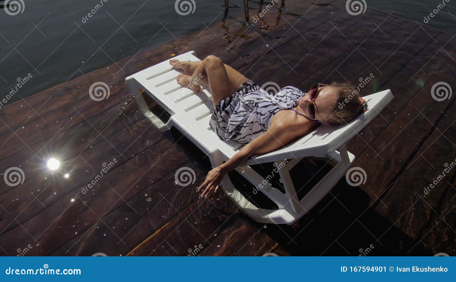 Woman Lie on a Sunbed in Sunglasses and a Boho Silk Shawl. Girl Rest on ...