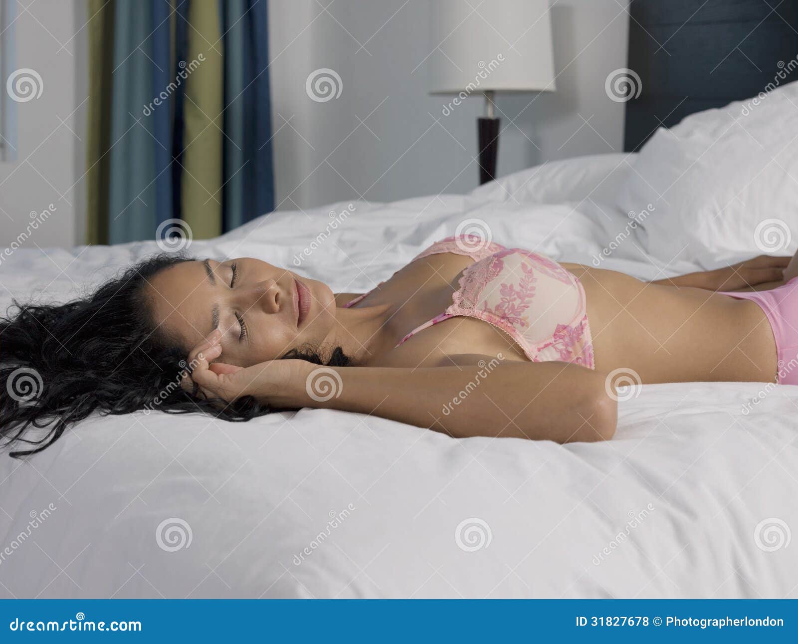 Woman in lingerie sleeping on the bed Stock Photo