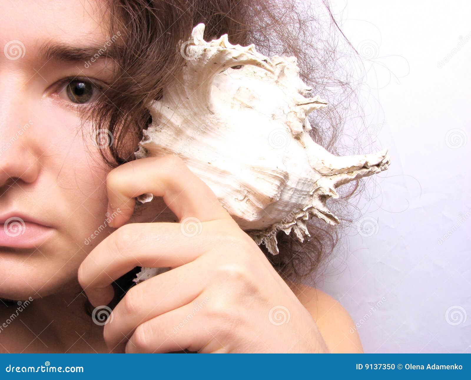 Woman Listening To The Seashell Stock Photo - Image: 9137350