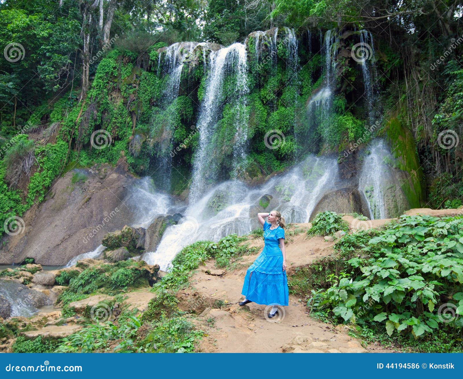 woman in a long dress near waterfalls soroa, pinar del rio, cuba