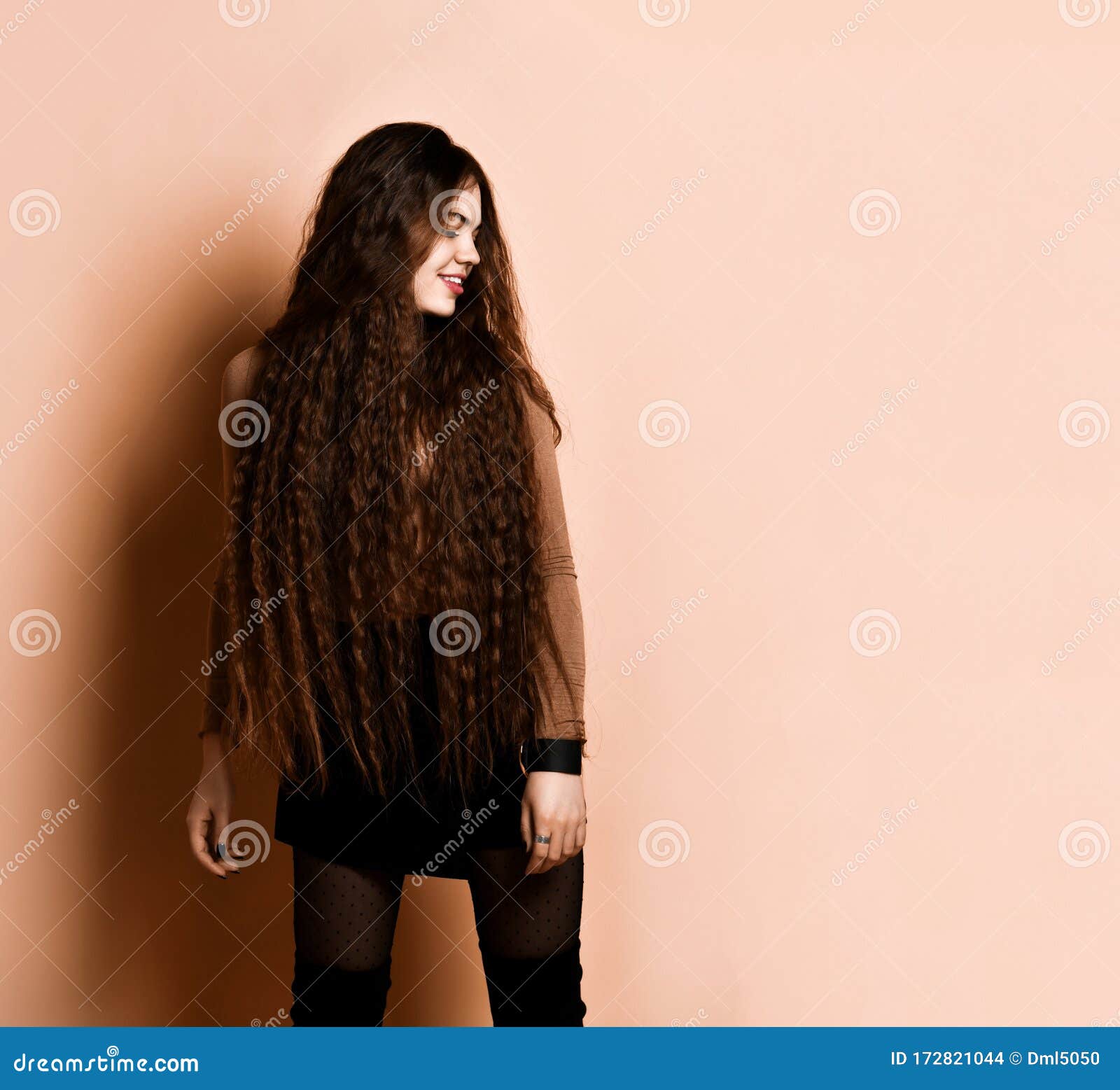Woman with Long Hair, in Brown Turtleneck, Short Skirt, Nylon Tights,  Boots. Smiling, Posing on Beige Background. Close Up Stock Photo - Image of  posing, figure: 172821044