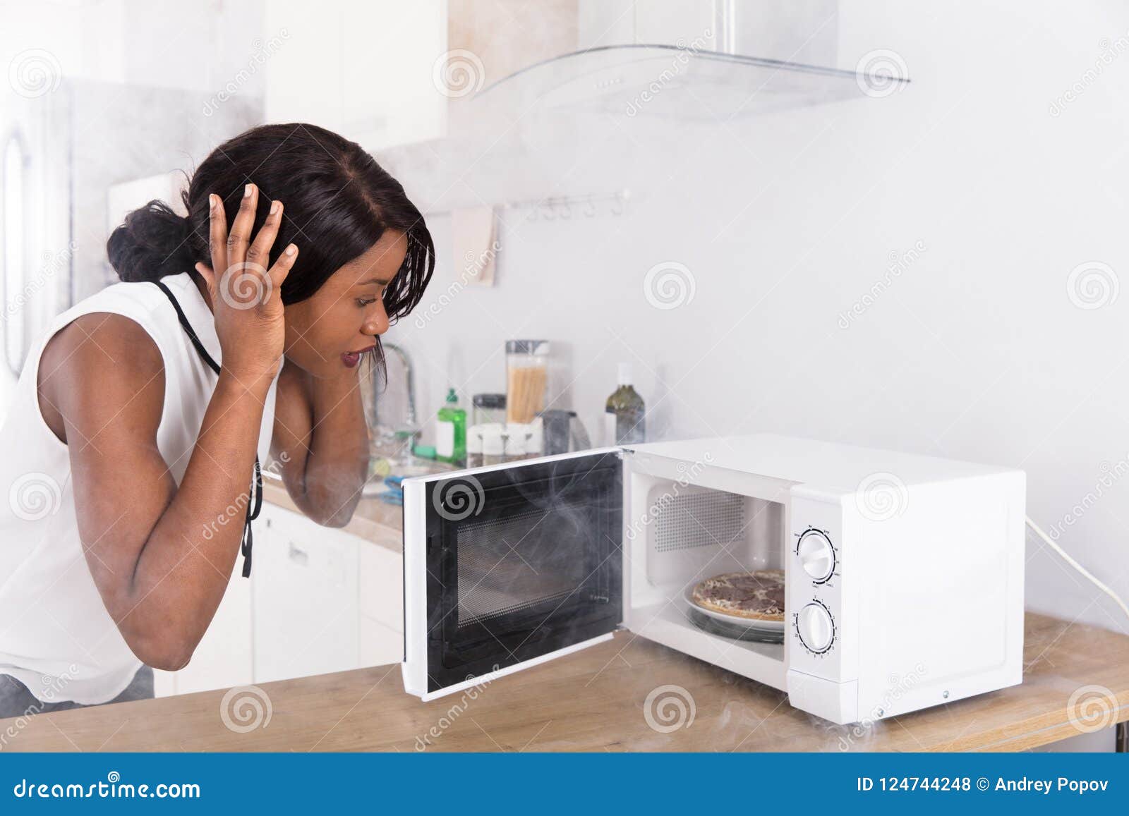 Free Photos - In This Stock Photo, A Young Woman With A Melancholic  Expression Is Standing Next To An Old, Dusty Microwave Oven In A Dimly Lit  Room. The Woman Seems To