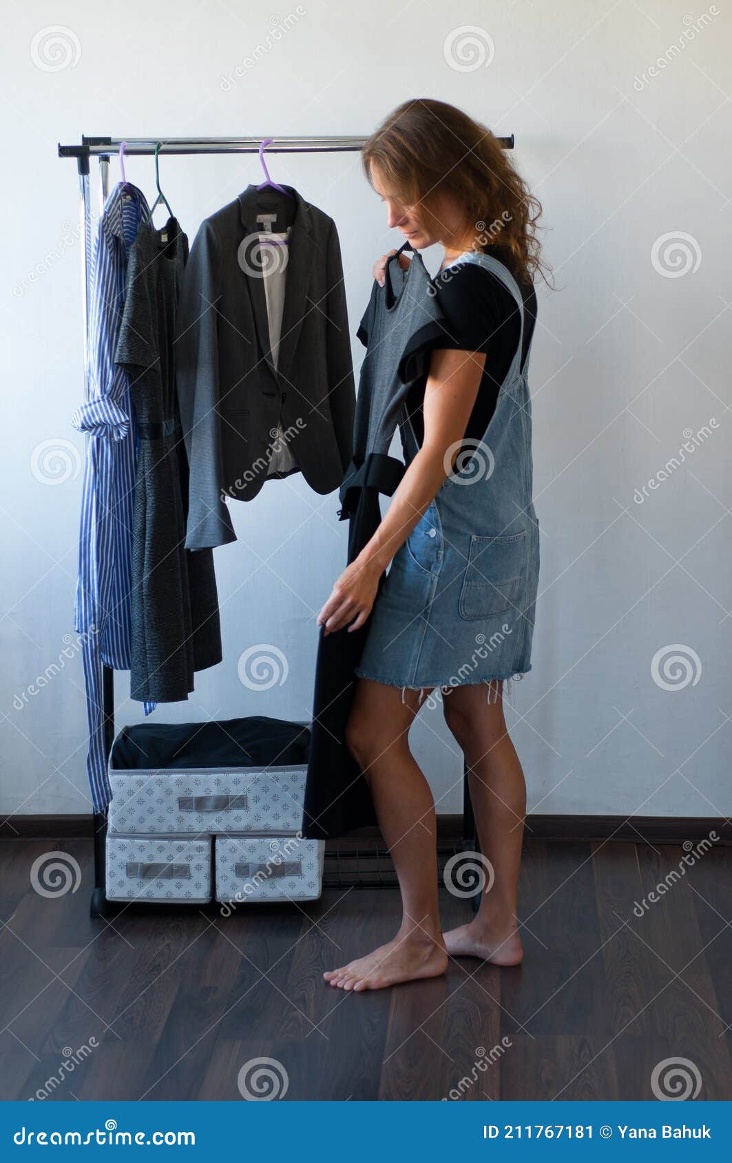 woman looking at clothes. young shopping fun. clothes on a rack