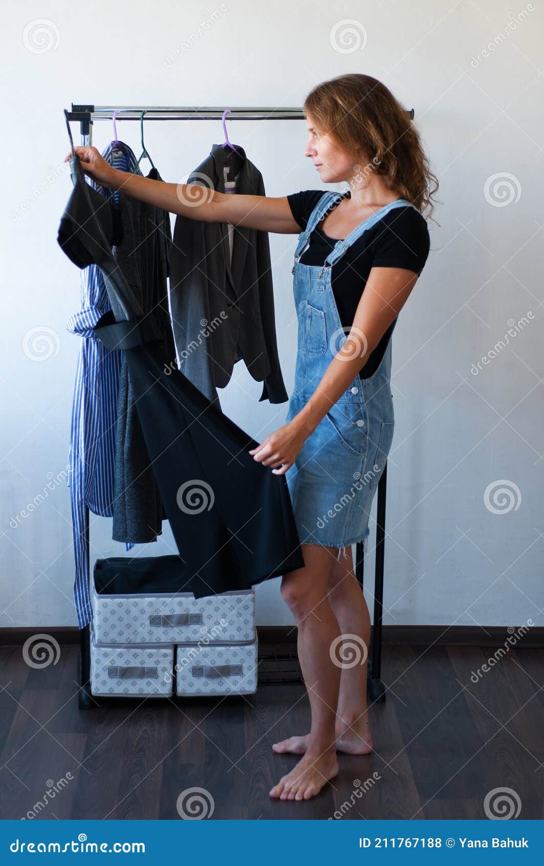 woman looking at clothes. young shopping fun. clothes on a rack