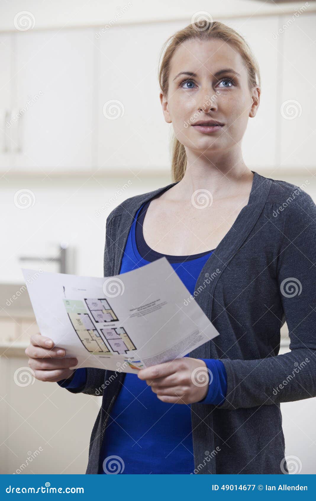 woman looking at details for property she hopes to buy