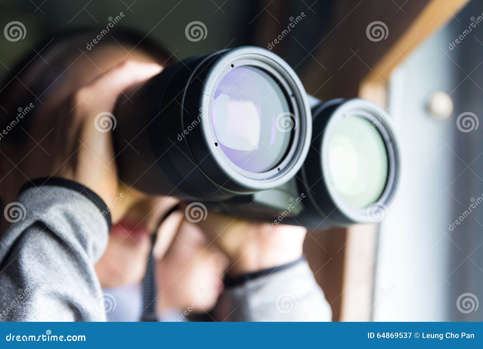 woman looking though binocular