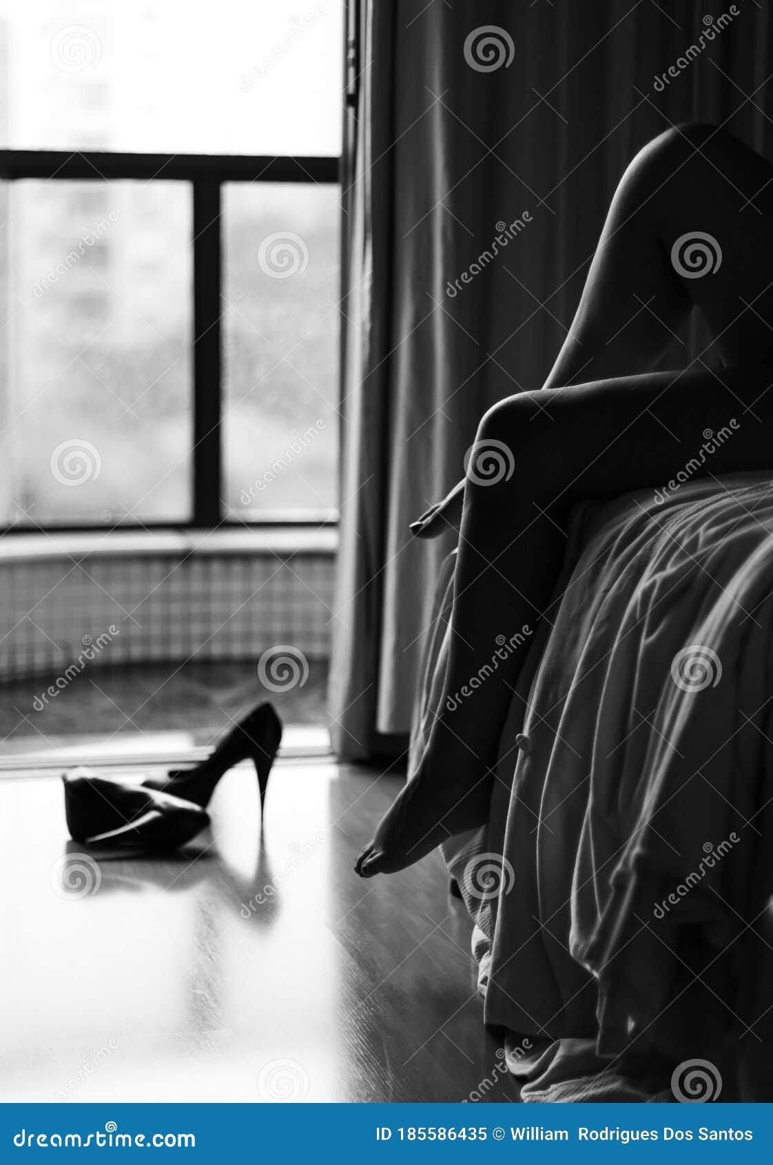 Woman Lying in Bed with Light Coming in through the Window and Lighting ...