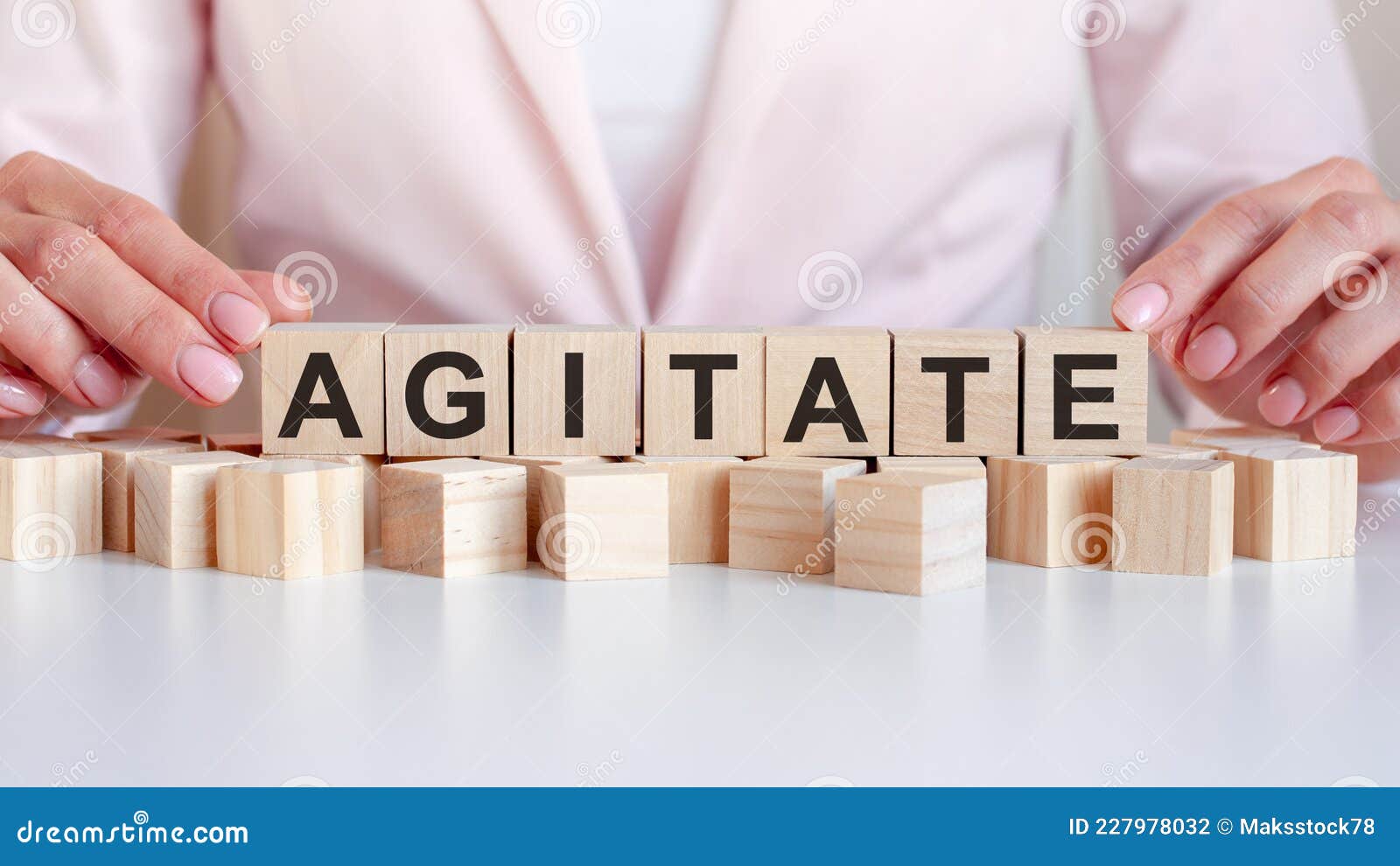 woman made word agitate with wooden blocks