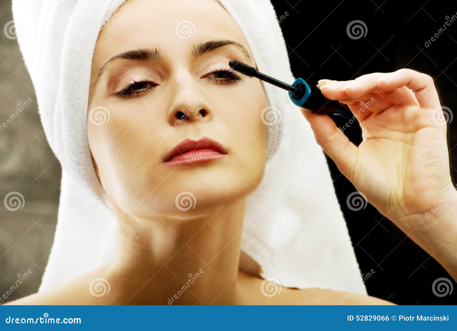 Woman Makes Light Day Makeup in Bathroom. Stock Photo Image of