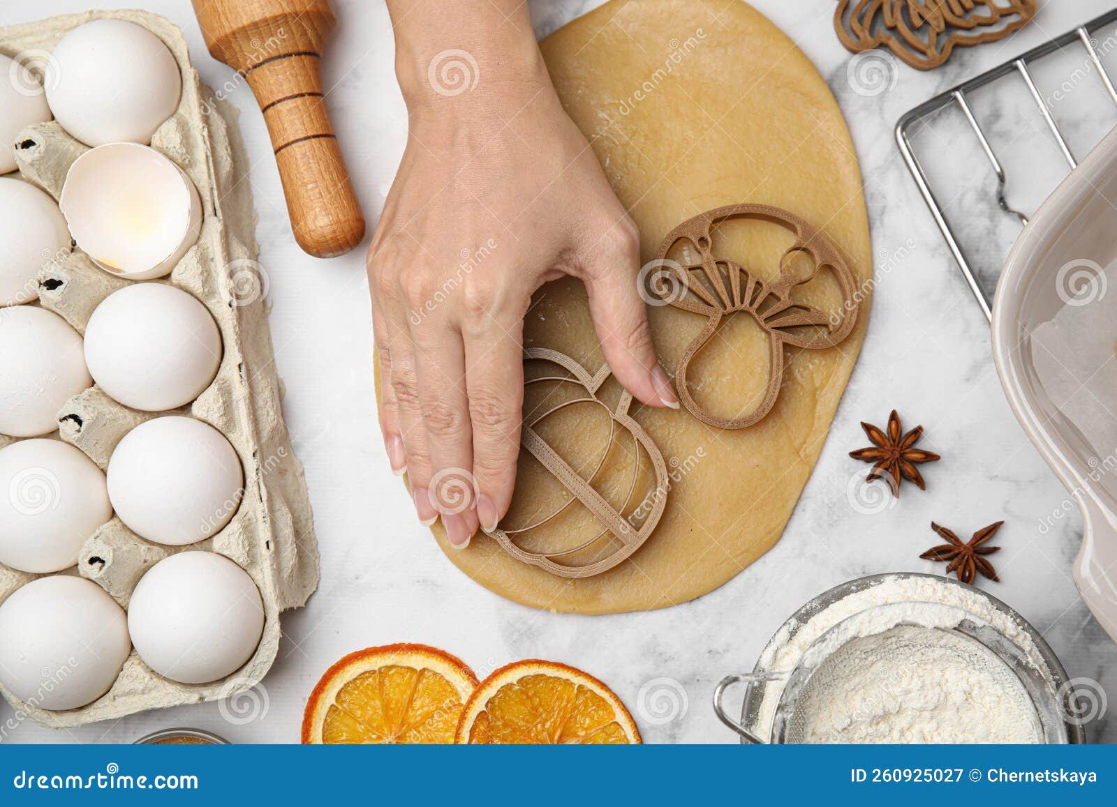 Woman Making Biscuits with Cookie Cutters on White Marble Table, Top