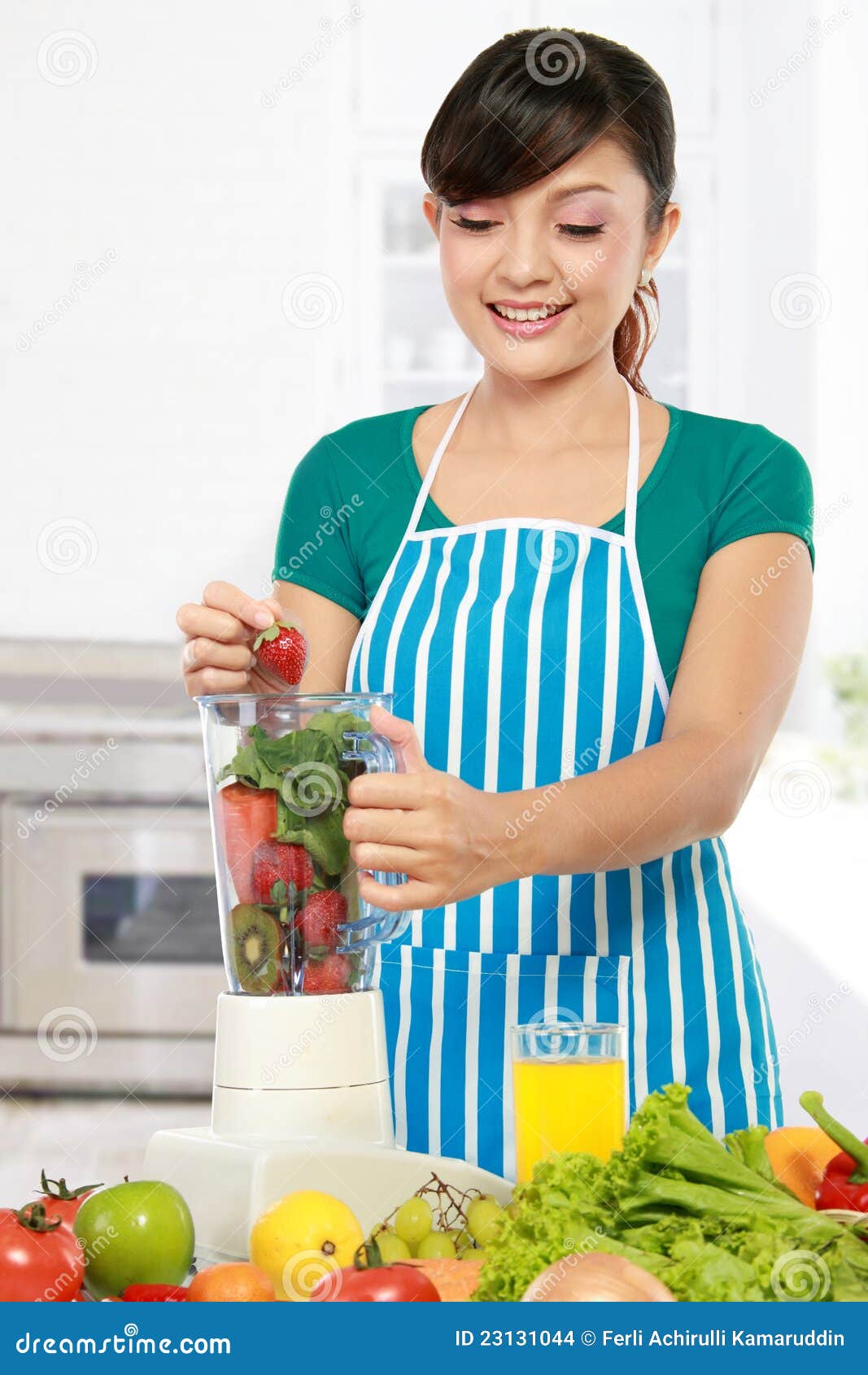 Woman making a fresh juice stock photo. Image of indoors 23131044