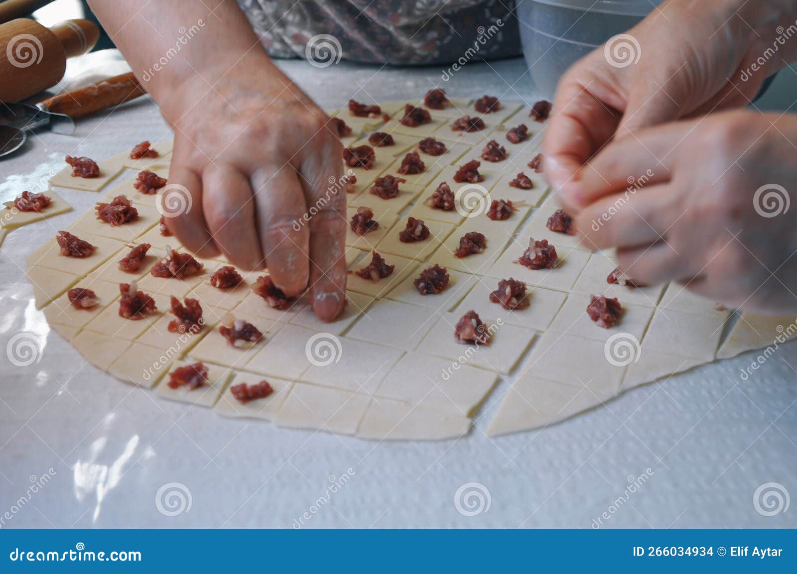 Woman Making Ravioli, Manti or Mantı. Traditional Turkish Patty Stuffed with Minced Meat