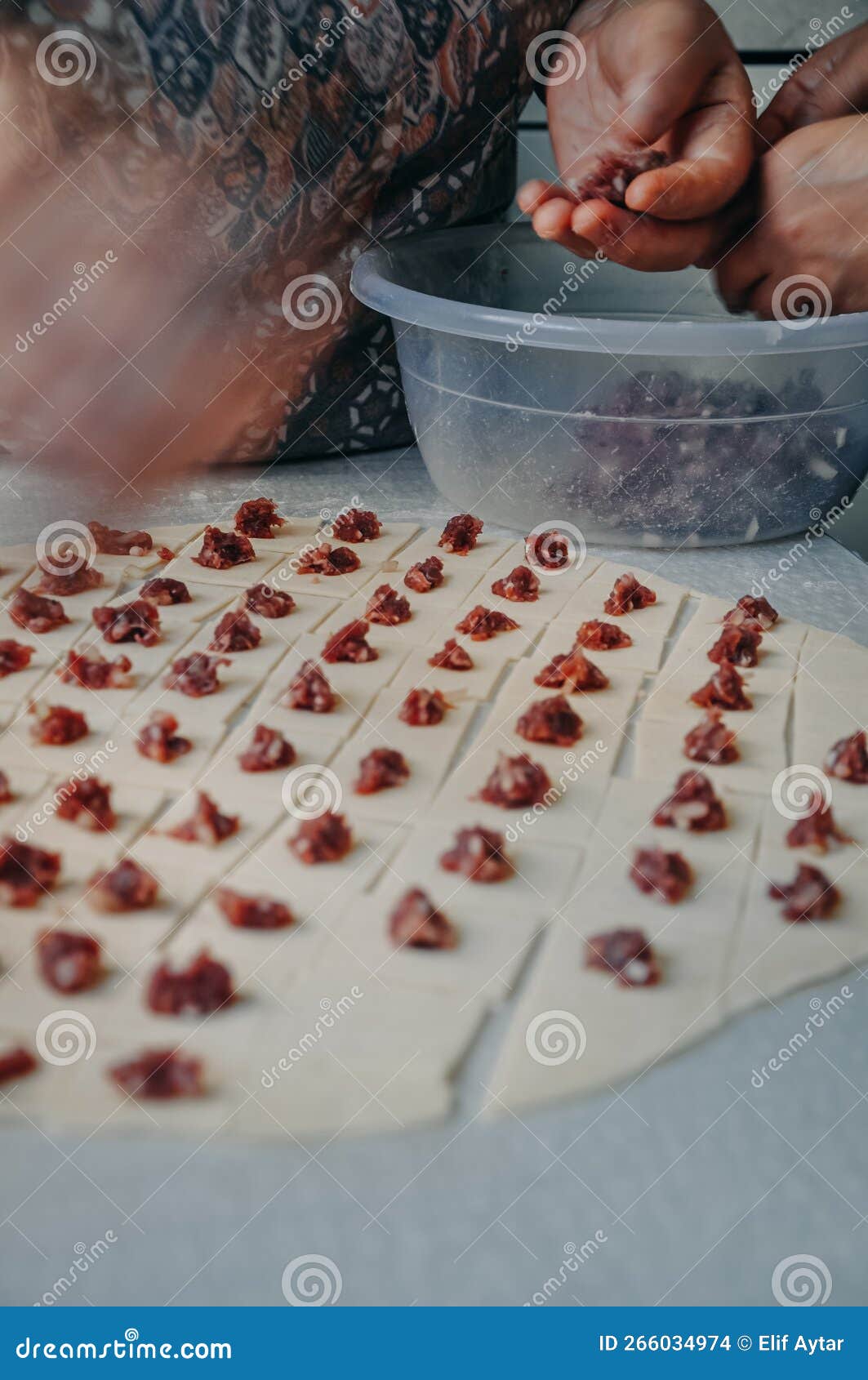 Woman Making Ravioli, Manti or Mantı. Traditional Turkish Patty Stuffed with Minced Meat