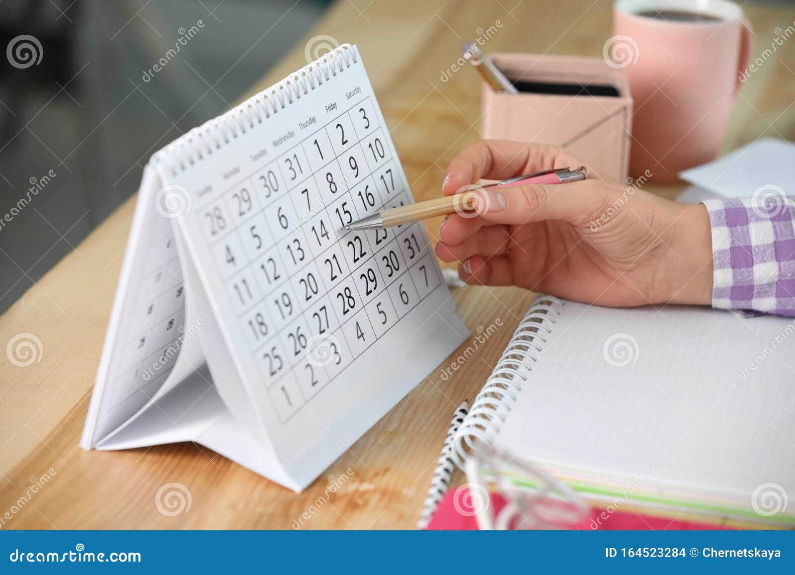 Woman Making Schedule Using Calendar At Table Stock Photo Image