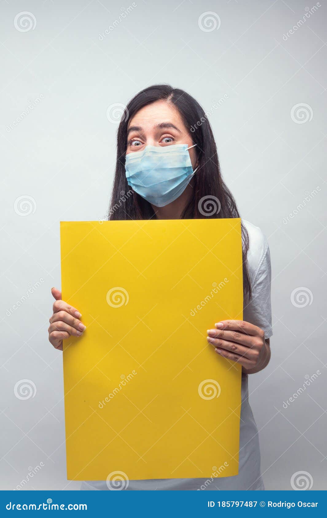 woman with mask and yellow sign - vertical