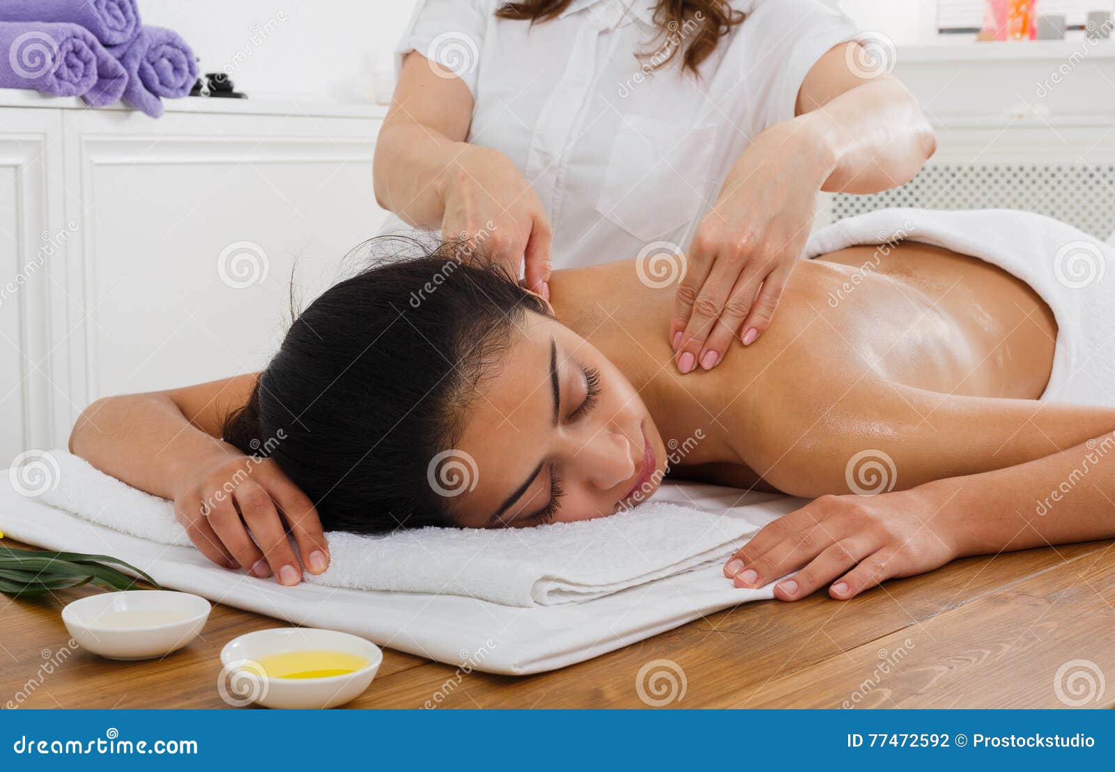 woman massagist make body massage in spa wellness center