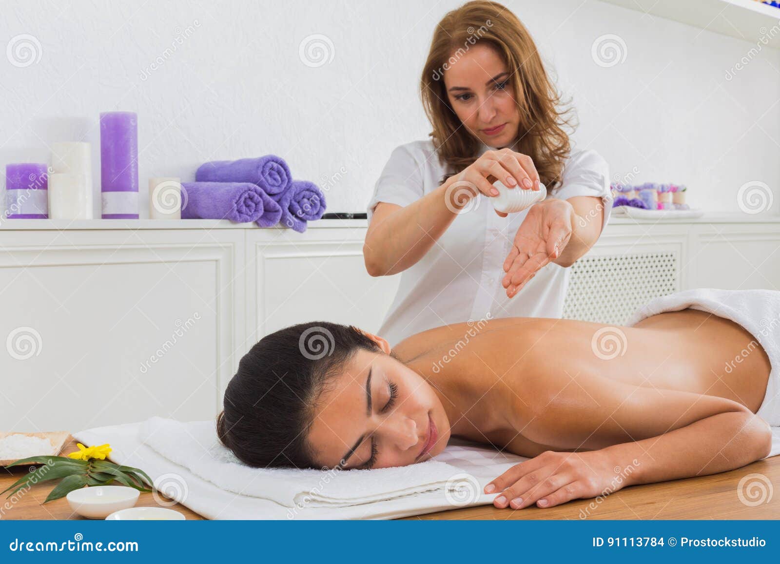 woman massagist make body massage in spa wellness center